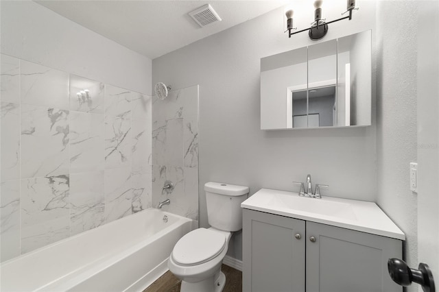 full bathroom with toilet, vanity, visible vents, baseboards, and  shower combination