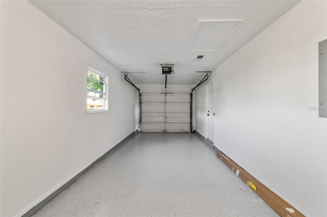 garage with visible vents, baseboards, and a garage door opener