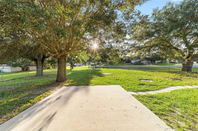 view of property's community featuring fence and a yard