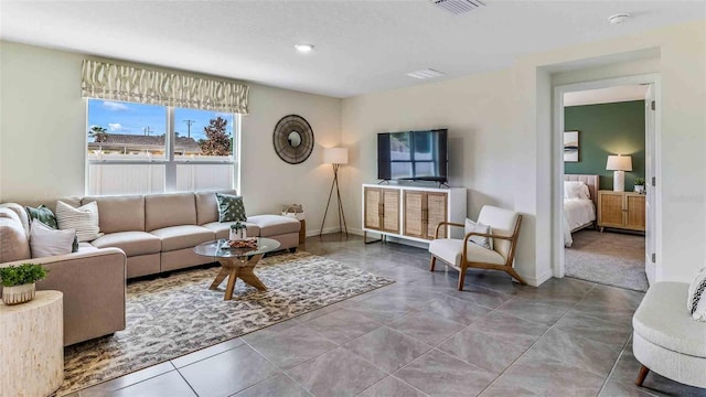 tiled living area with visible vents and baseboards