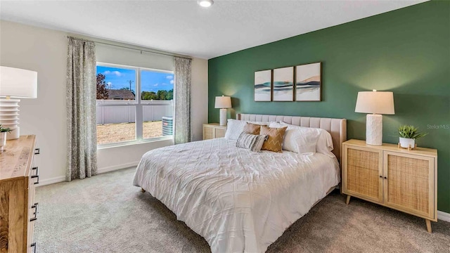 carpeted bedroom featuring baseboards