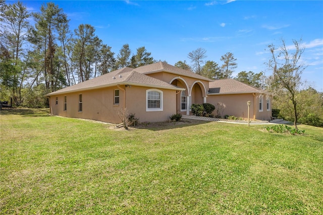 ranch-style house with a front lawn and stucco siding