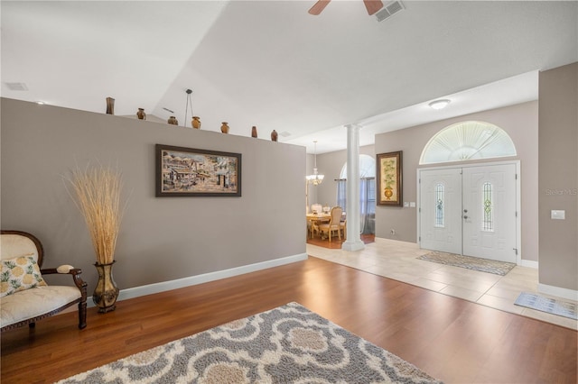 entryway with visible vents, decorative columns, baseboards, and wood finished floors