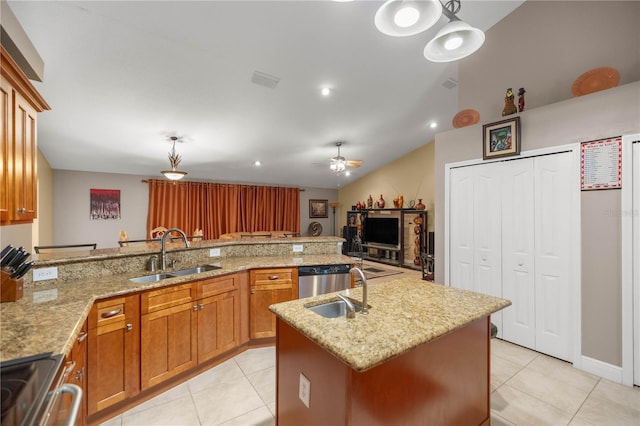 kitchen featuring light tile patterned floors, appliances with stainless steel finishes, brown cabinetry, a sink, and ceiling fan