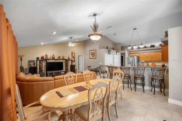 dining space featuring vaulted ceiling, visible vents, ceiling fan, and light tile patterned floors