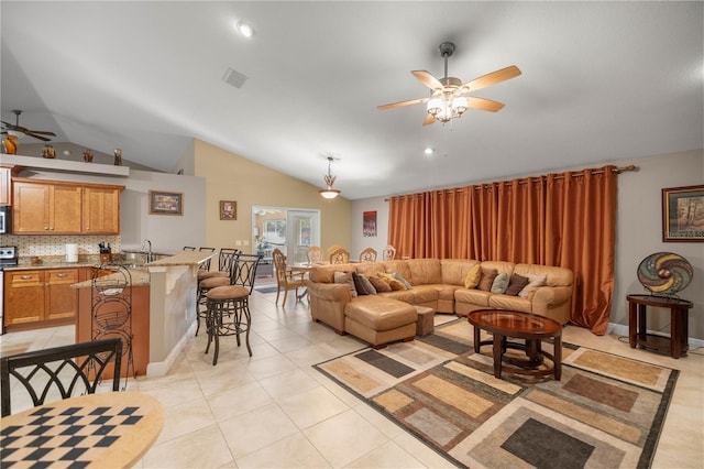 living area featuring ceiling fan, light tile patterned flooring, lofted ceiling, and visible vents