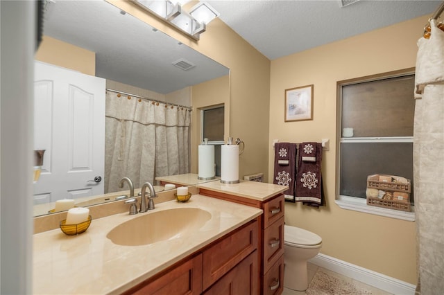 full bath with tile patterned flooring, toilet, vanity, visible vents, and baseboards