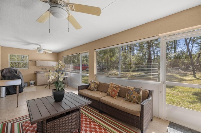 sunroom / solarium with a healthy amount of sunlight and ceiling fan