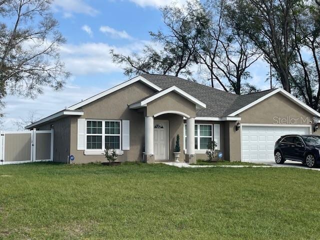 single story home with a front lawn, an attached garage, and stucco siding