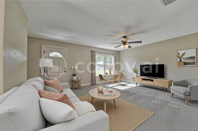 carpeted living area featuring a ceiling fan, visible vents, and baseboards