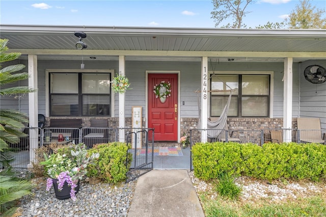 entrance to property featuring a porch