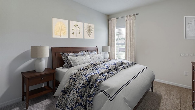 carpeted bedroom featuring baseboards