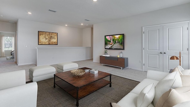 living area featuring recessed lighting, visible vents, light carpet, and baseboards