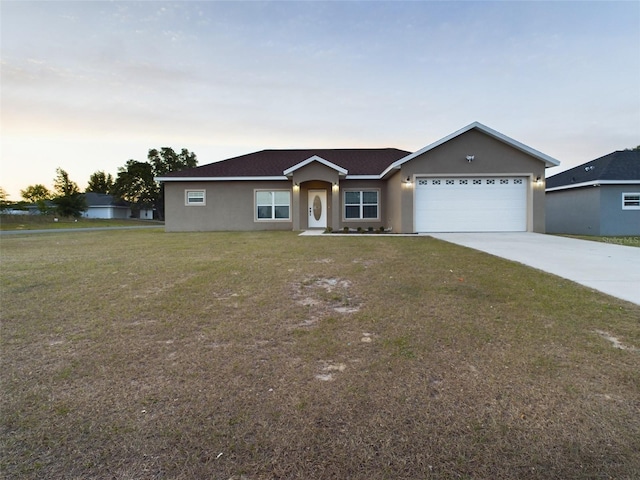 ranch-style home with stucco siding, driveway, a garage, and a front lawn