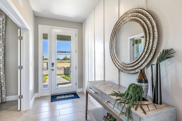 entrance foyer featuring tile patterned floors and baseboards