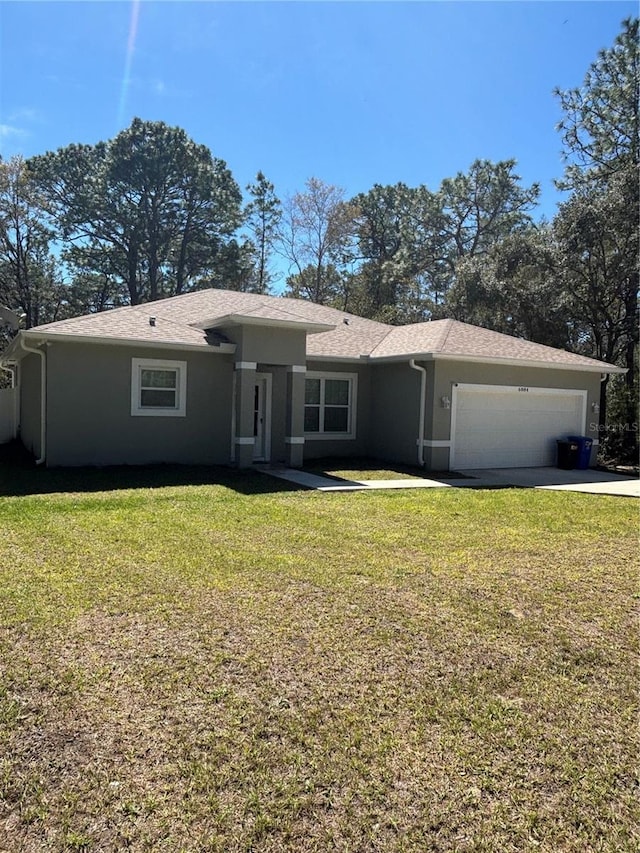 ranch-style home featuring a garage, driveway, a front lawn, and stucco siding