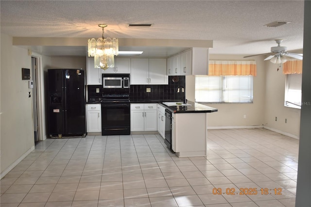 kitchen featuring visible vents, black appliances, a sink, dark countertops, and decorative backsplash