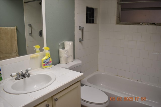 bathroom with shower / tub combination, toilet, and vanity