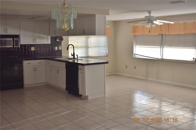 kitchen featuring electric stove, a sink, stainless steel microwave, dark countertops, and dishwasher