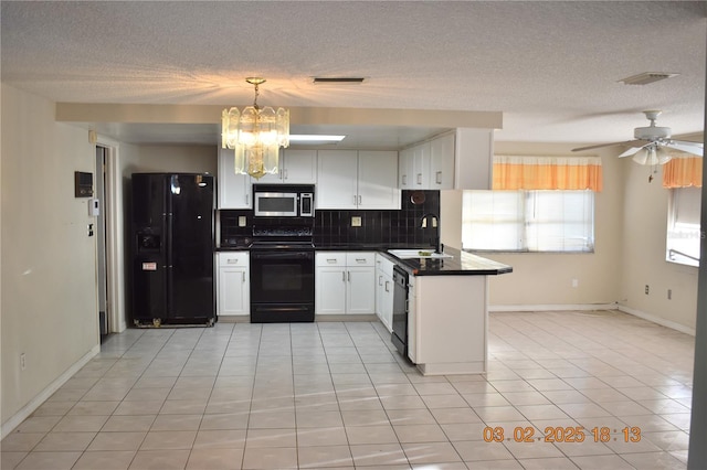 kitchen featuring visible vents, black appliances, a sink, tasteful backsplash, and dark countertops