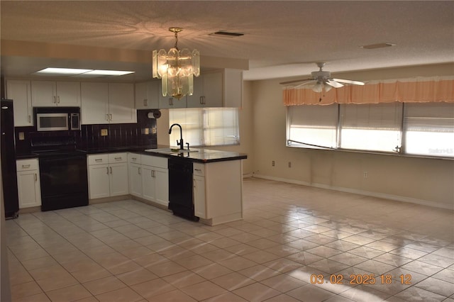 kitchen featuring a sink, decorative backsplash, black appliances, white cabinetry, and dark countertops