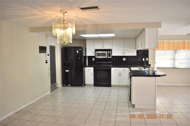 kitchen with dark countertops, visible vents, backsplash, black appliances, and a sink