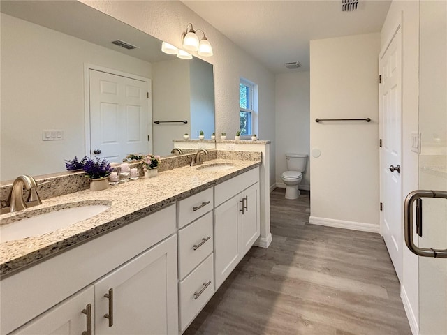 1370 SW Obee Ridge Rd, Dunnellon, FL 34432 - bathroom featuring double vanity and wood finished floors