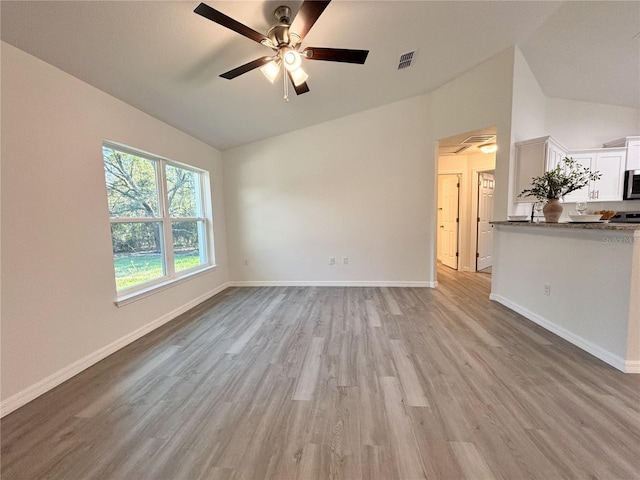 1370 SW Obee Ridge Rd, Dunnellon, FL 34432 - unfurnished living room featuring a ceiling fan, light wood-type flooring, and high vaulted ceiling