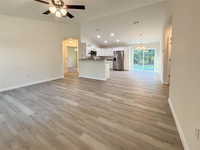 1370 SW Obee Ridge Rd, Dunnellon, FL 34432 - unfurnished living room with vaulted ceiling, a ceiling fan, light wood-style flooring, and recessed lighting