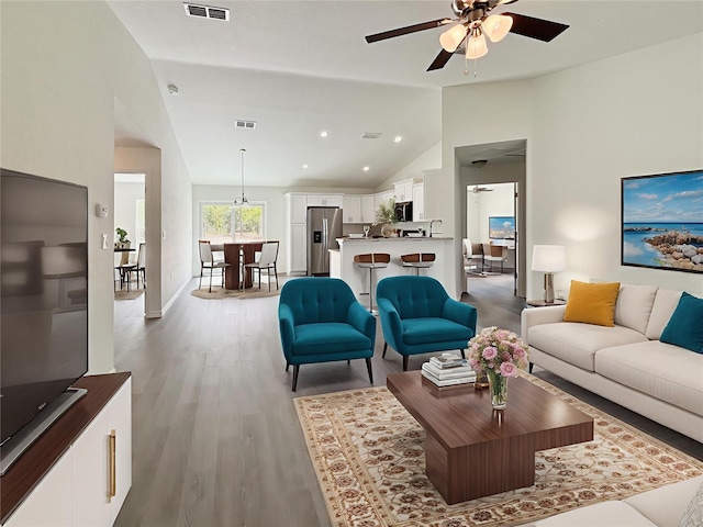 1370 SW Obee Ridge Rd, Dunnellon, FL 34432 - living area with vaulted ceiling, a ceiling fan, wood finished floors, and recessed lighting