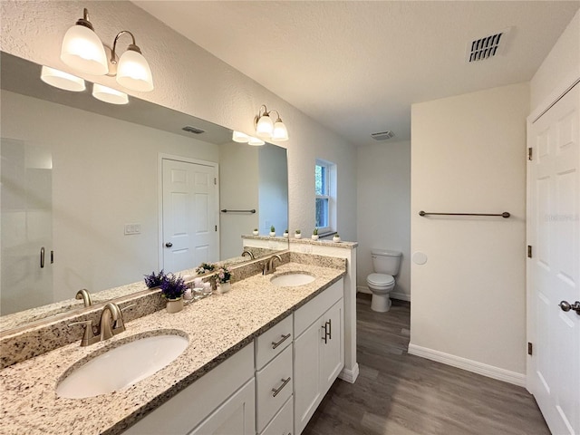 1370 SW Obee Ridge Rd, Dunnellon, FL 34432 - bathroom featuring wood finished floors, double vanity, and a shower stall