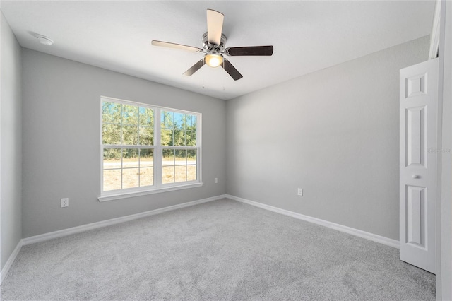 empty room with baseboards, carpet, and a ceiling fan