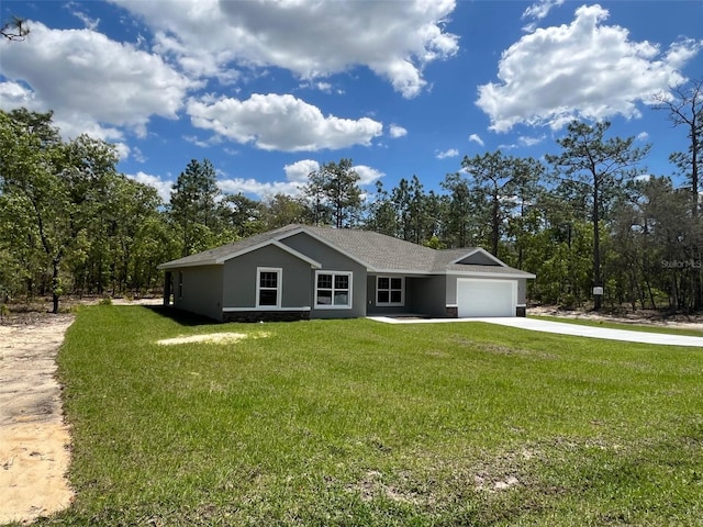 ranch-style home featuring stucco siding, driveway, a garage, and a front yard