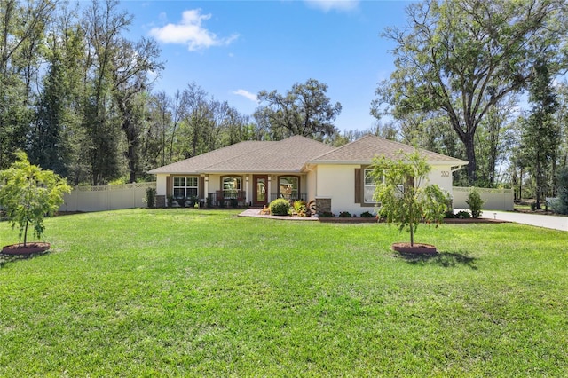 ranch-style house with a front yard, fence, and stucco siding