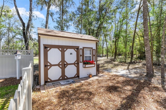 view of shed featuring fence