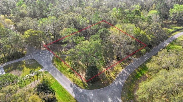 drone / aerial view featuring a forest view