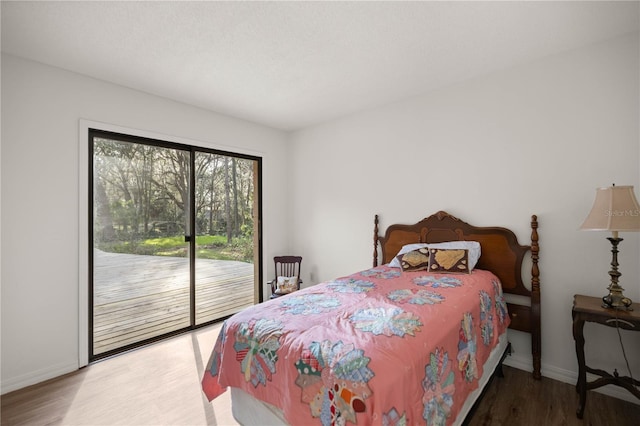 bedroom with access to outside, baseboards, and wood finished floors