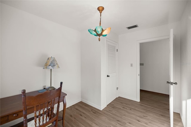 interior space with light wood finished floors, visible vents, and baseboards