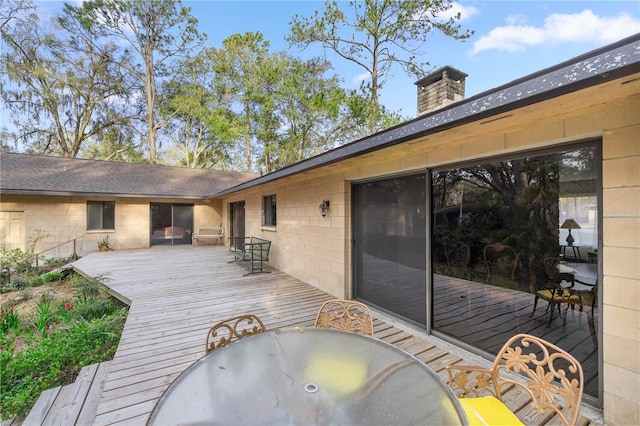 wooden terrace with outdoor dining area