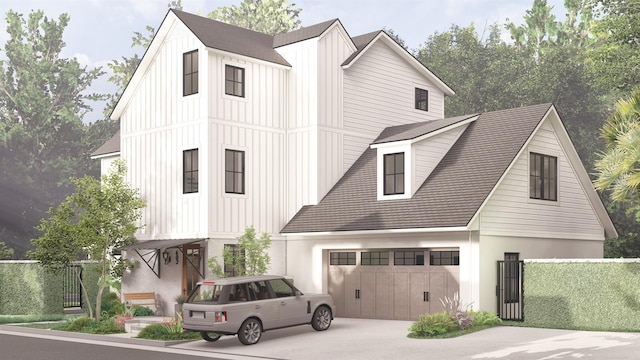 modern farmhouse with a garage, driveway, board and batten siding, and fence