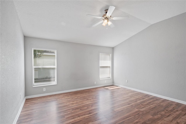 4954 SW 40th Pl, Ocala, FL 34474 - unfurnished room featuring vaulted ceiling, ceiling fan, wood finished floors, a textured wall, and baseboards