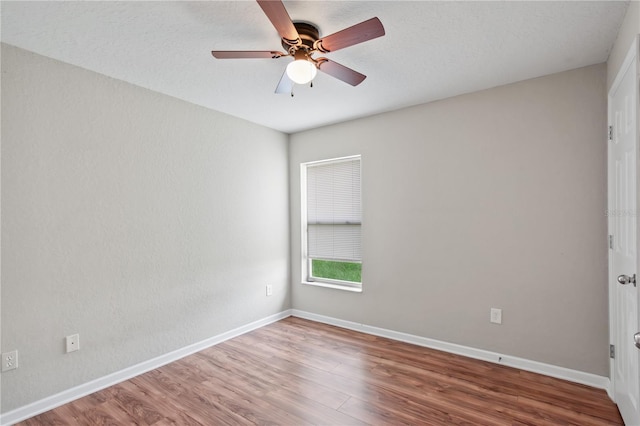 4954 SW 40th Pl, Ocala, FL 34474 - spare room featuring ceiling fan, wood finished floors, and baseboards