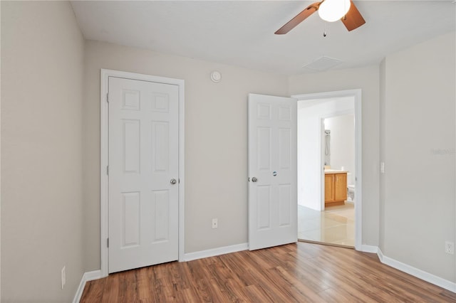 4954 SW 40th Pl, Ocala, FL 34474 - unfurnished bedroom featuring wood finished floors, baseboards, and a ceiling fan