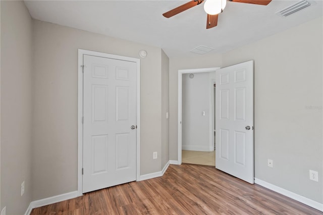 4954 SW 40th Pl, Ocala, FL 34474 - unfurnished bedroom featuring baseboards, wood finished floors, and ceiling fan