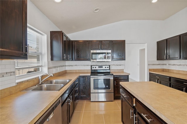 4954 SW 40th Pl, Ocala, FL 34474 - kitchen featuring stainless steel appliances, a sink, vaulted ceiling, backsplash, and light countertops