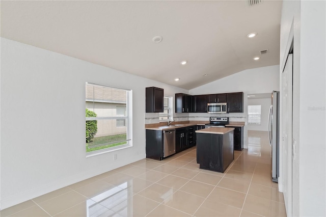 4954 SW 40th Pl, Ocala, FL 34474 - kitchen featuring appliances with stainless steel finishes, a sink, lofted ceiling, light countertops, and a kitchen island