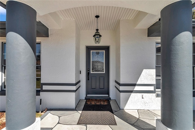 view of exterior entry with stucco siding