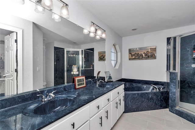 full bath featuring a stall shower, a sink, and tile patterned floors