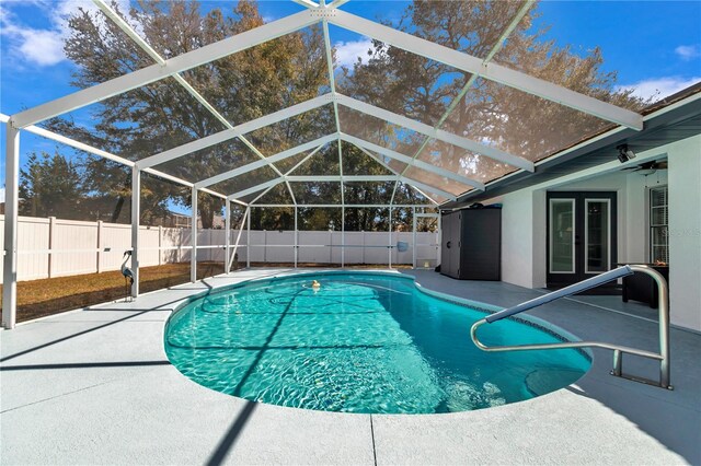 view of pool with a lanai, a fenced backyard, a fenced in pool, and a patio