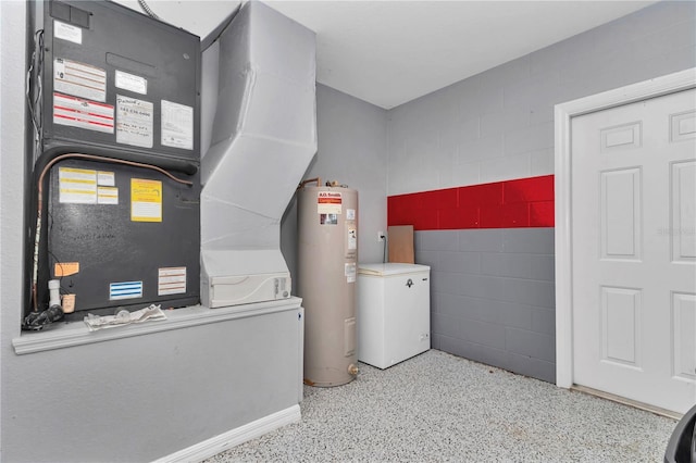 clothes washing area featuring laundry area, water heater, and heating unit